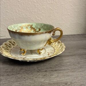 Elegant Gold and Cream Teacup with Saucer